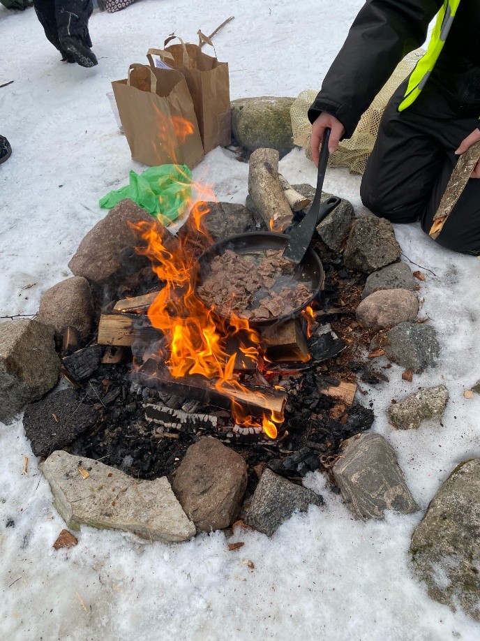 Bilde av bål med steking av reinsdyrkjøtt.